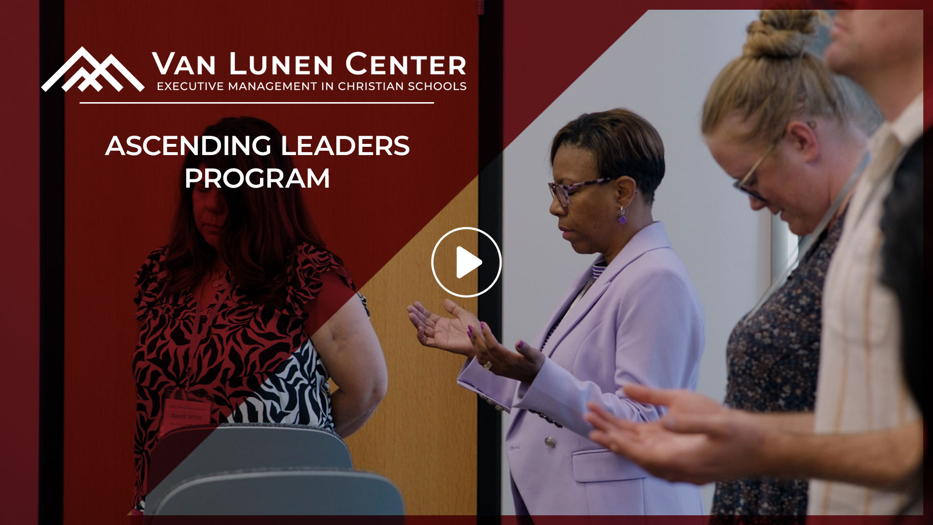Van Lunen Ascending Leaders hold their hands with palms facing upwards as they pray together.