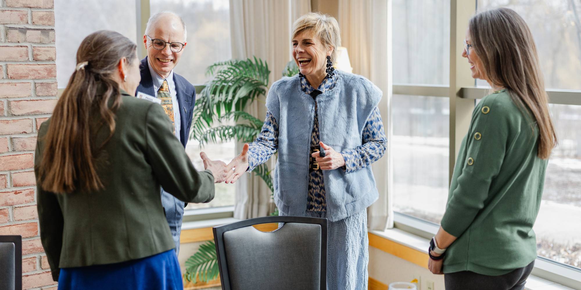 Princess Laurentien of the Netherlands greeting faculty on Calvin University's campus.