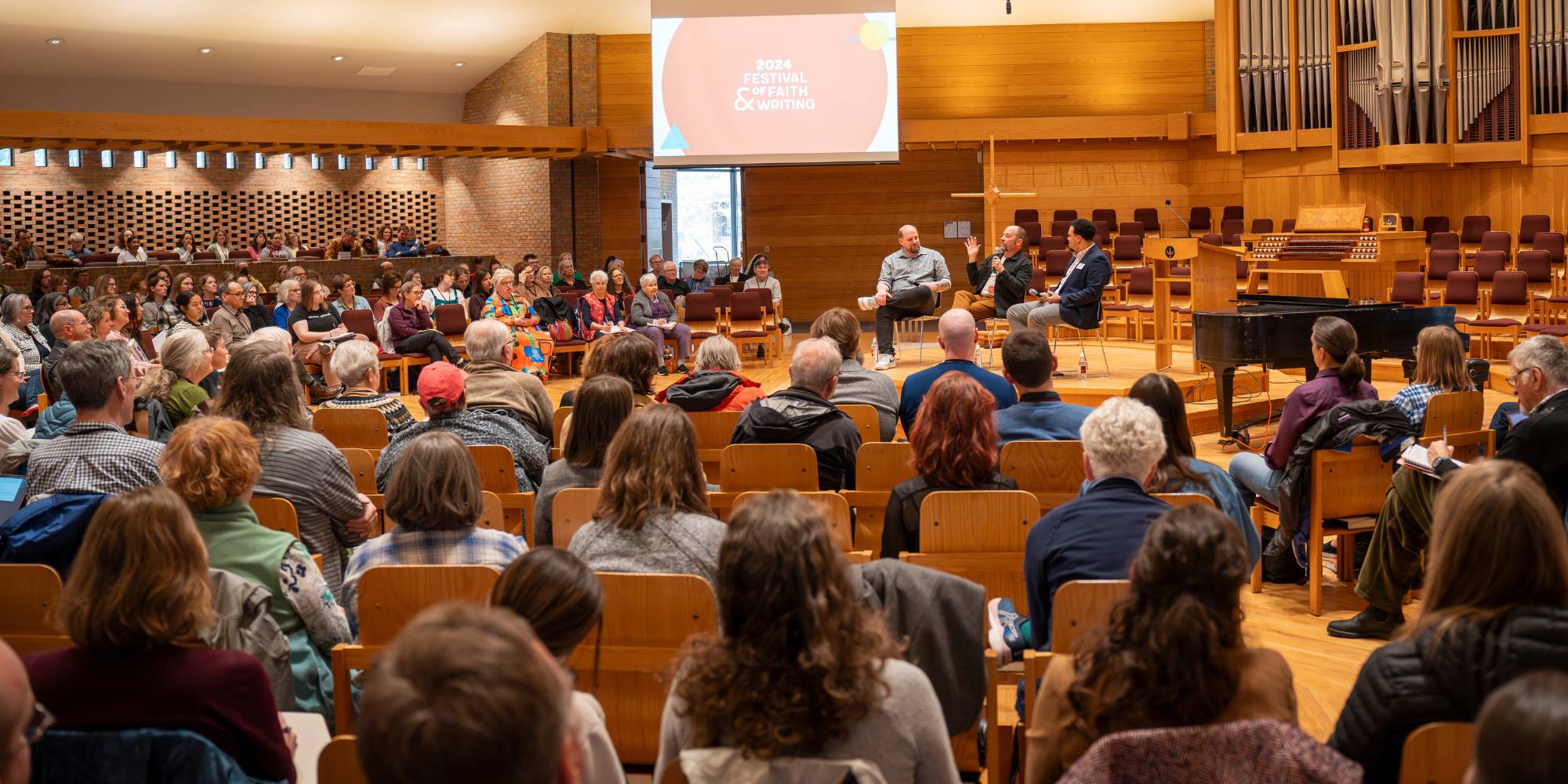 A crowd listens to a panel of speakers at the Festival of Faith and Writing at Calvin University.