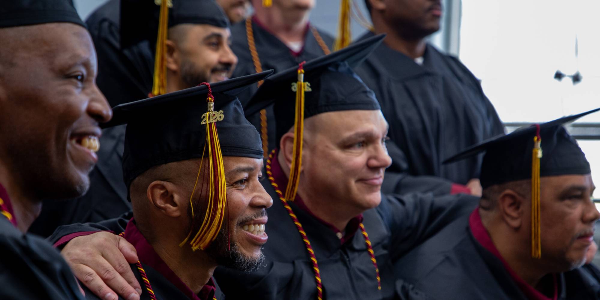 Graduates of the Calvin Prison Initiative arm in arm