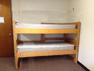 Bunk beds stacked traditionally, one on top of the other.