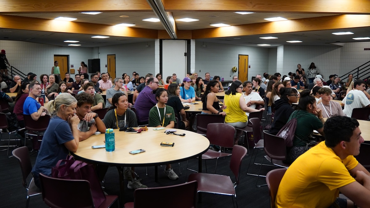 New students and families sit around tables at the Impact Welcome Lunch.