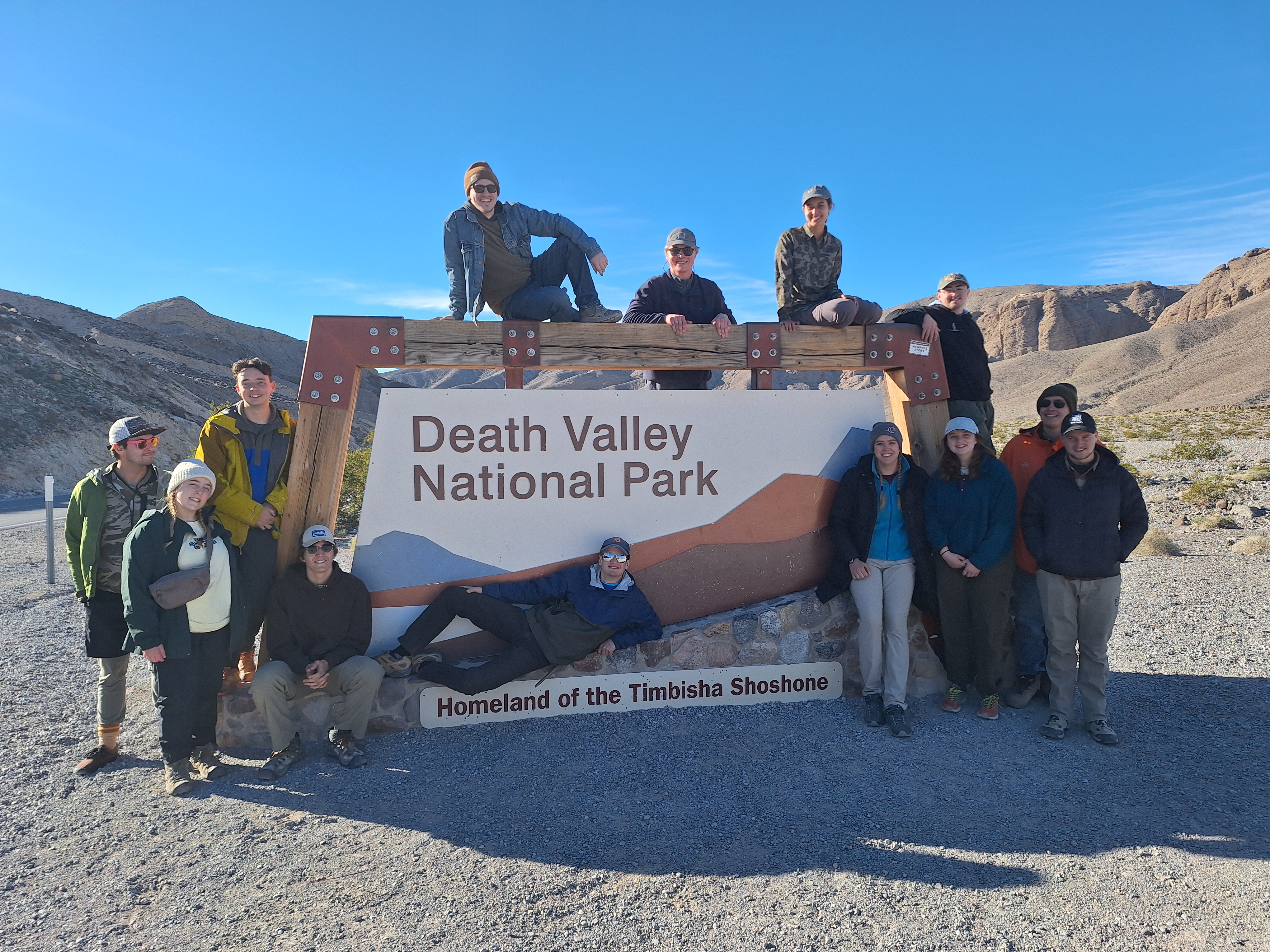 2024 Death Valley National Park Winter Intensive Group Photo in front of Death Valley National Park sign