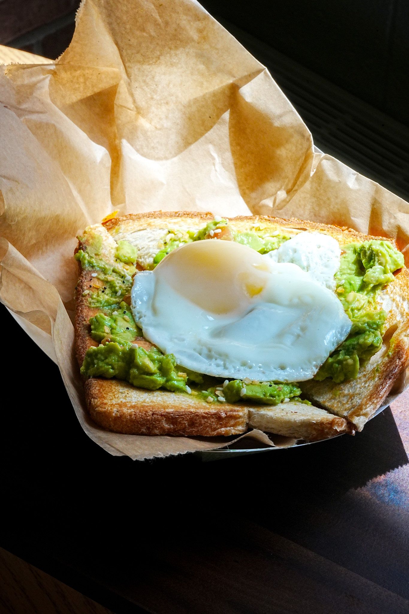Avocado toast with sunny side up egg on top.