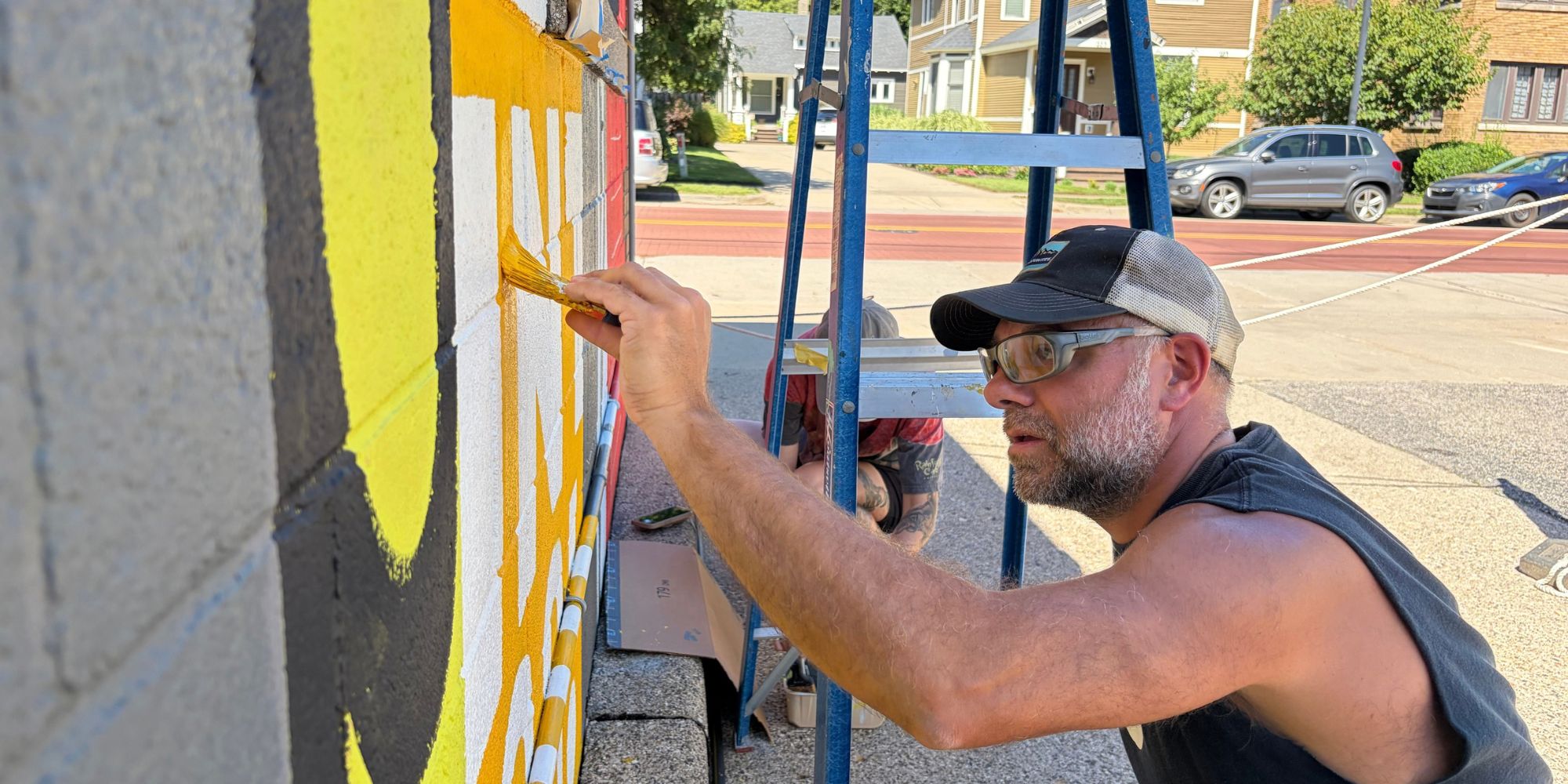 Chris Fox, professor of graphic design at Calvin University, painting a mural in Grand Rapids, Michigan.