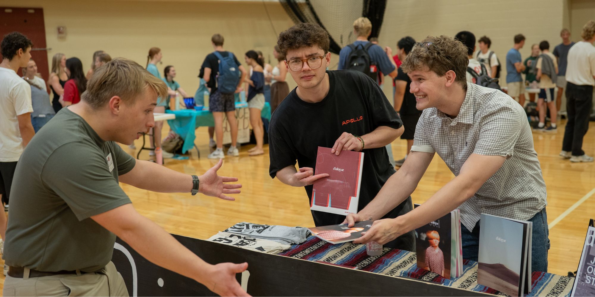 Students gather at a table highlighting Dialogue, a student organization at Calvin