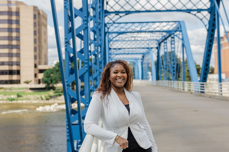 Noro Dung poses on the blue bridge in Grand Rapids.