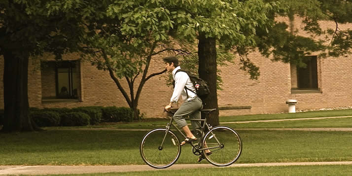 A student rides a bike.