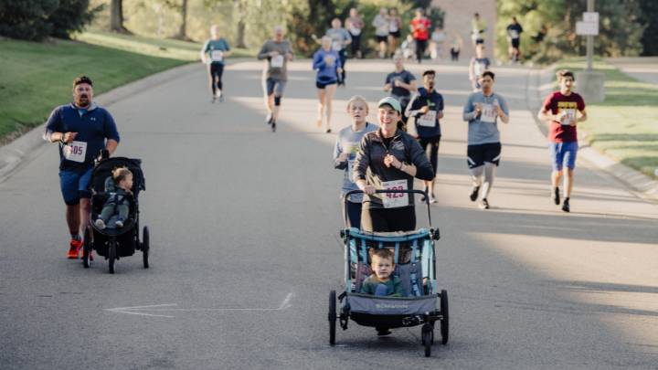 People running on Calvin University's campus in fall.