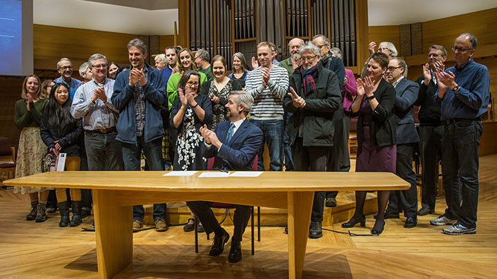 After signing the climate commitment, President Le Roy celebrates with faculty, staff and students who have been instrumental to sustainability efforts at the college.