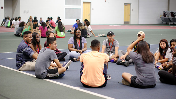 Entrada Scholars participate in a team-building exercise in the Huizenga Tennis & Track Center.