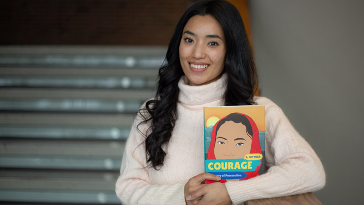 Senior Freshta Tori Jan holds her new book, Courage: My Story of Persecution.