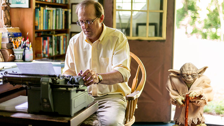 Best-selling author and Calvin College English professor Gary Schmidt writing from his home office in Alto, Michigan.