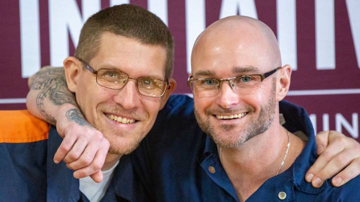 Two male students in the Calvin Prison Initiative program smiling with arms around each other.