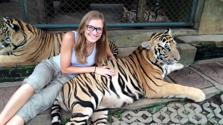 Linnea Venhousen cuddles with a tiger at Tiger Kingdom in Thailand