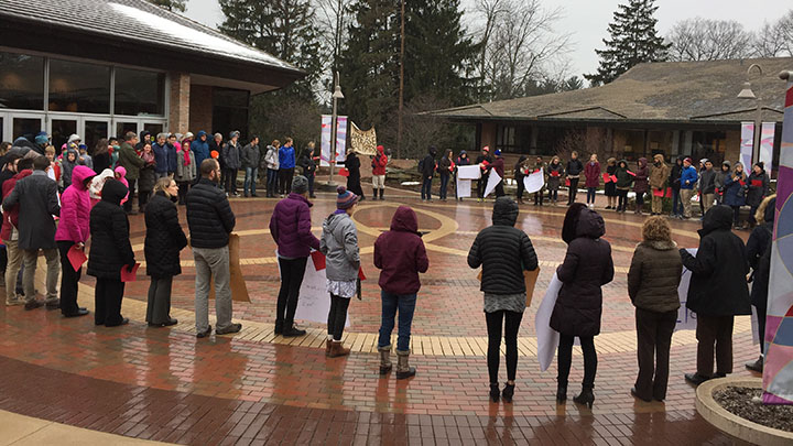 In 2017, Calvin College administrators, faculty, staff, and students join with members of the Grand Rapids community to pray before the MLK Day Silent March around campus.