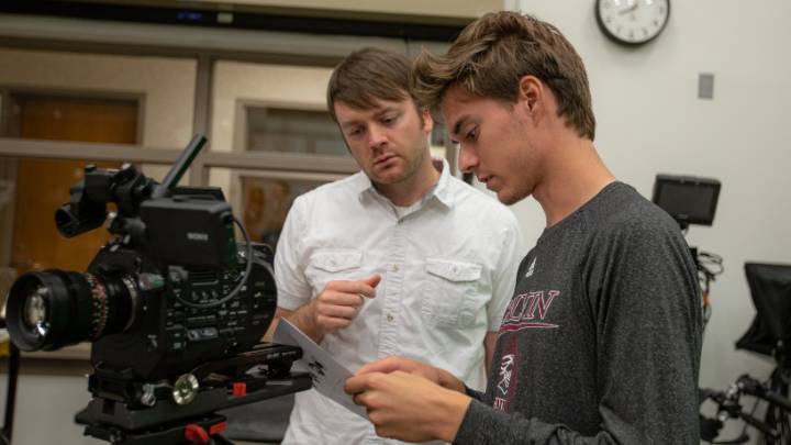 Award-winning documentary filmmaker Sam Smartt works with a student in one of the studios at Calvin University.