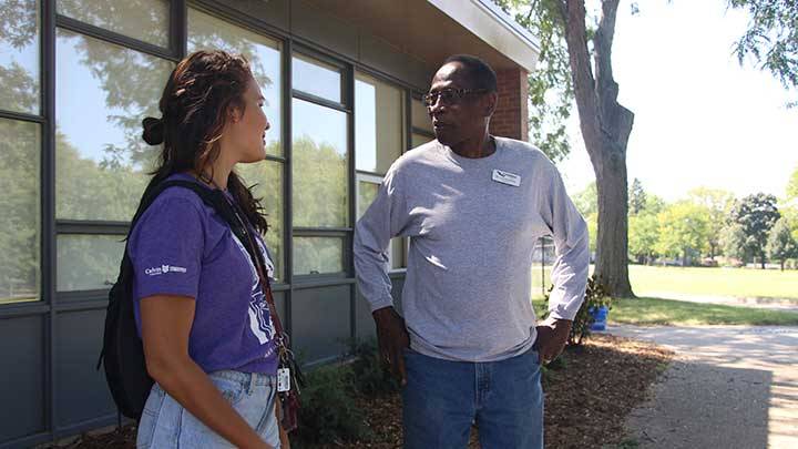 Calvin student talking to a professor on campus in Grand Rapids, Michigan