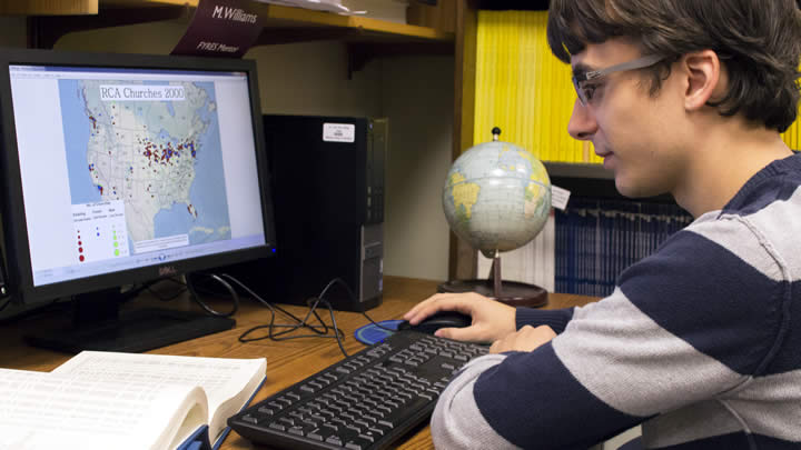 Matt Raybaud reviewing one of the maps he created for his project.