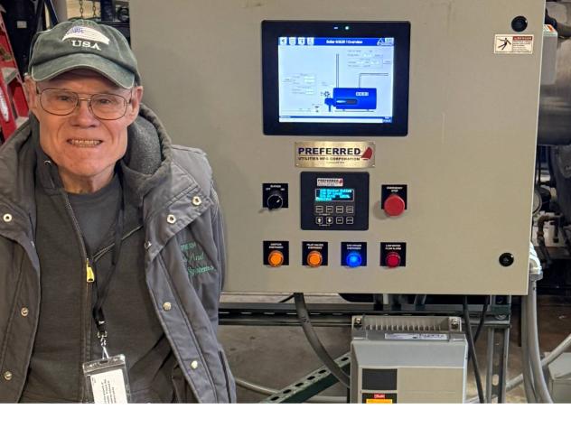 John Wiesehan standing in front of a boiler at Calvin University