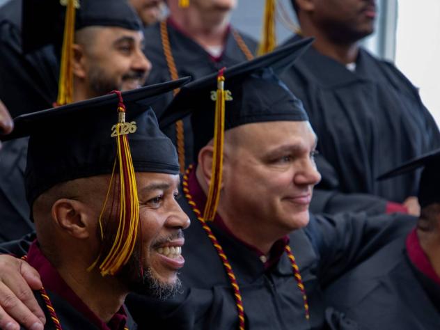 Graduates of the Calvin Prison Initiative arm in arm