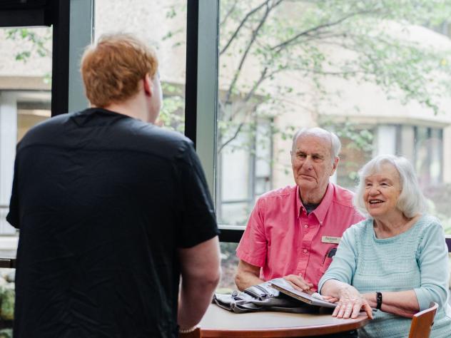 A student interacts with residents of Holland Home
