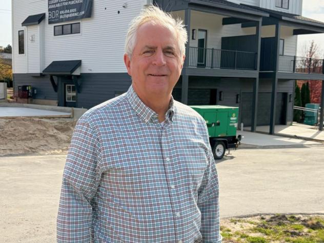 Kevin Einfeld, president of BDR Executive Custom Homes, Inc., standing in front of one of his properties.