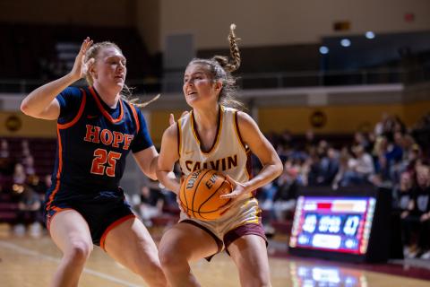 Calvin Women's basketball player dribbling ball on basketball court