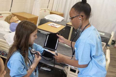 girls practicing taking vitals