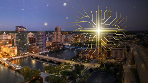 A graphic design of technology nodes forming a cross shape overlays a nightime river and city scape of Grand Rapids, Michigan.