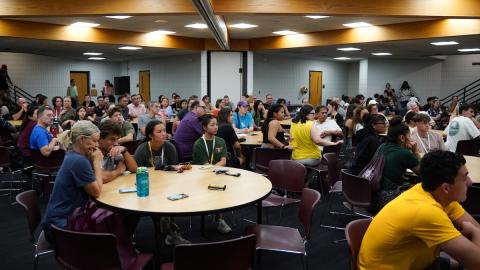 New students and families sit around tables at the Impact Welcome Lunch.