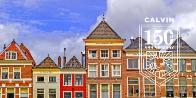 A row of colorful brick houses with many windows and pointed roofs, in Delft, Netherlands.