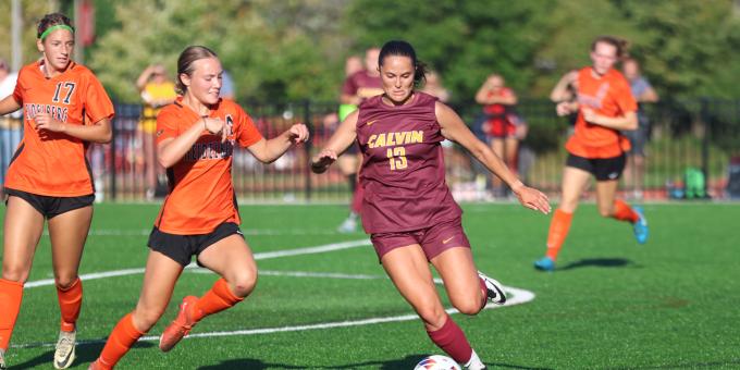 Calvin University women's soccer player about to kick the soccer ball