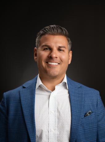 Man wearing a nice blazer and smiling 