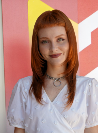 Photo of Kelsey Hooten in front of Calvin logo. 