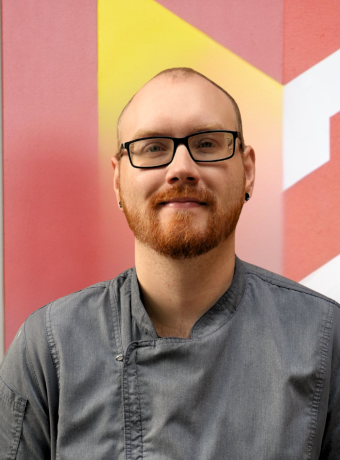 Photo of Kyle Redmond in front of Calvin logo. 