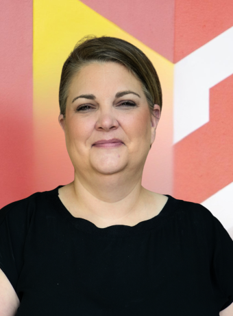 Photo of Heather Mendez in front of Calvin logo.