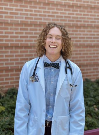 Photo of Jesse McCurdy. He has long curly hair and is a white male. 