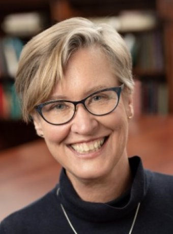 Nancy Jacobs in a black turtleneck sweater smiling