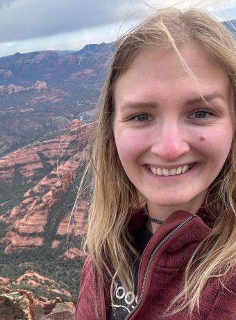 Olivia Kutsche smiling headshot with grand canyon in background