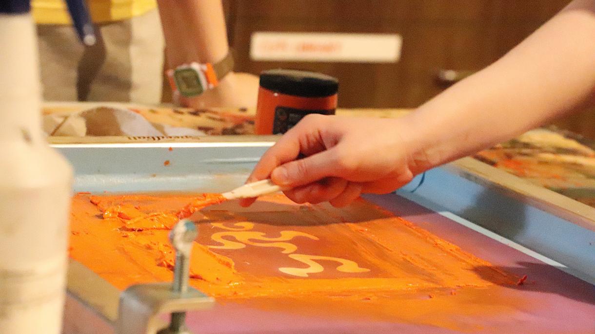 Custom tees are screen printed by students each year