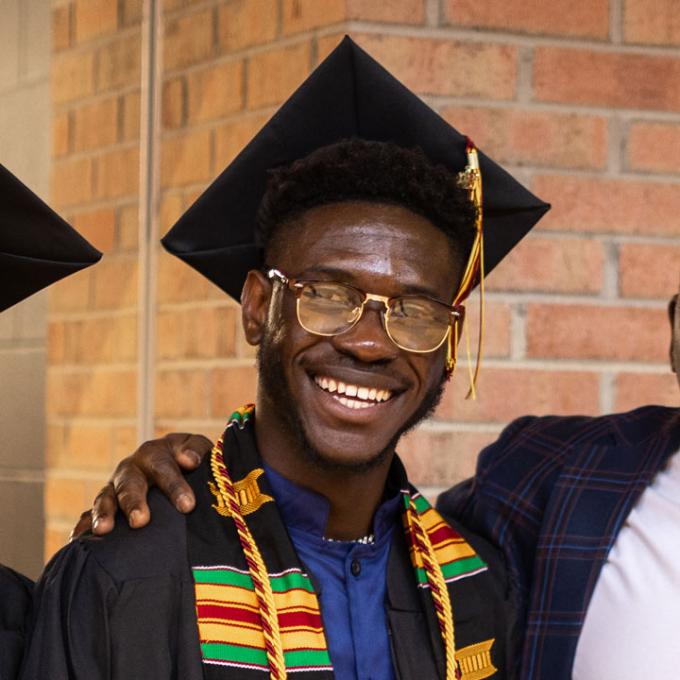 Emmanuel Essien in cap and gown at commencement.
