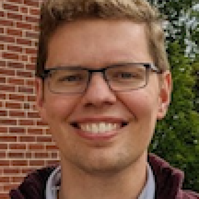Image of man with blond hair and glasses.