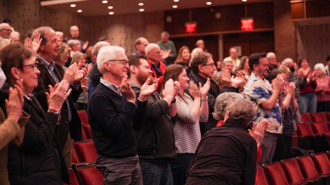 A group of people give a standing ovation at Calvin University January Series.