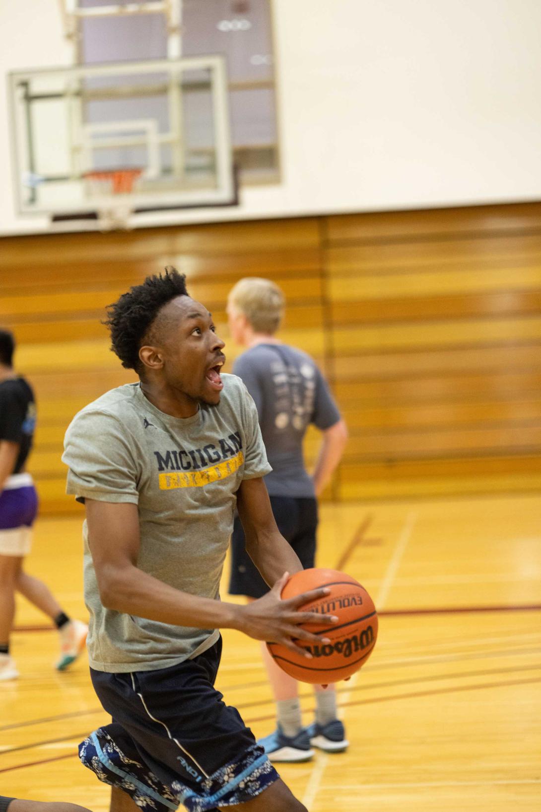 An intramural basketball player goes up for a layup.