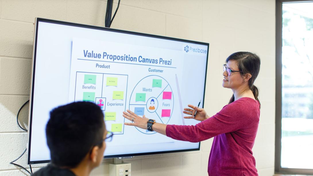 Teacher standing at a screen