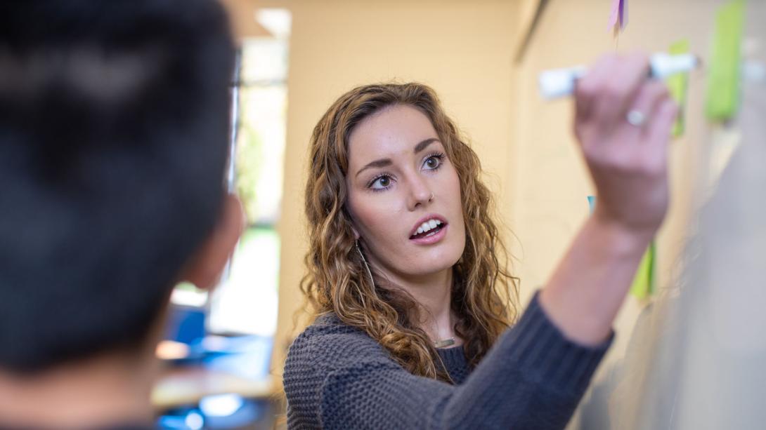 Woman writing on a whiteboard
