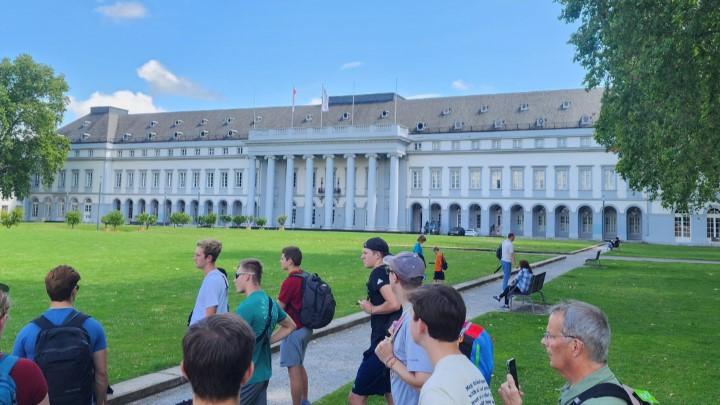 A study abroad trip in Germany, in front of a building with many windows and pillars.