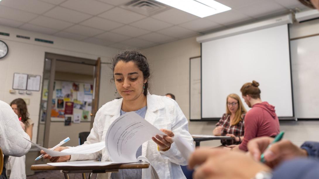 A woman flipping through paperwork