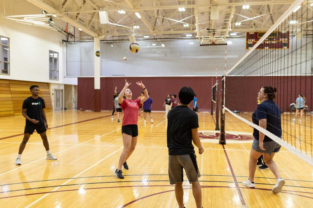 An intramural player sets the volleyball during a game.
